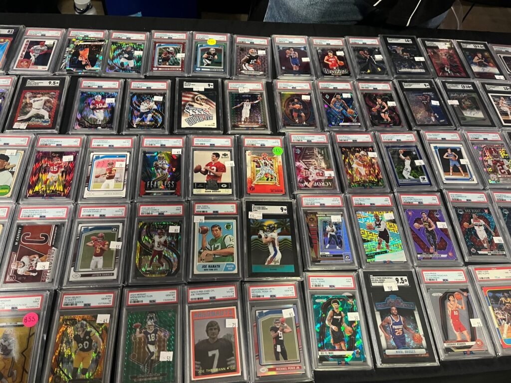 Table with graded sports cards laid out.